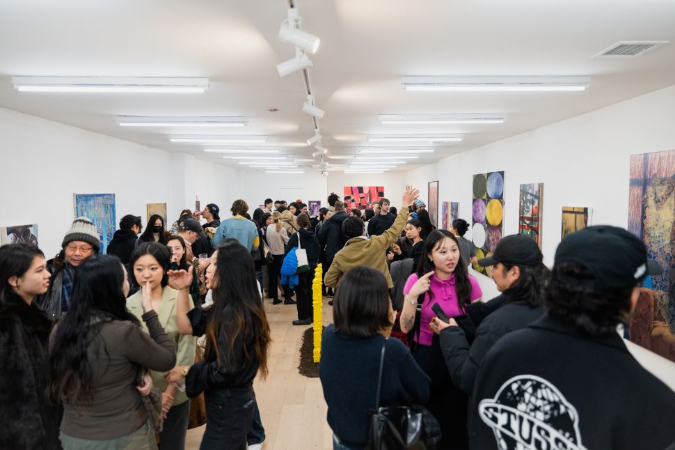 Visitors mingle in a crowded gallery during the “No Place Like Home” Art House group exhibition at LATITUDE gallery.