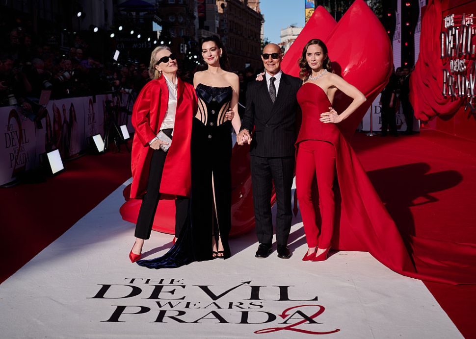 Meryl Streep, Anne Hathaway, Stanley Tucci and Emily Blunt pose for photos at a premiere event. 