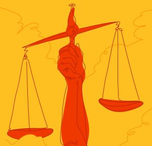 An arm holding the scales of justice