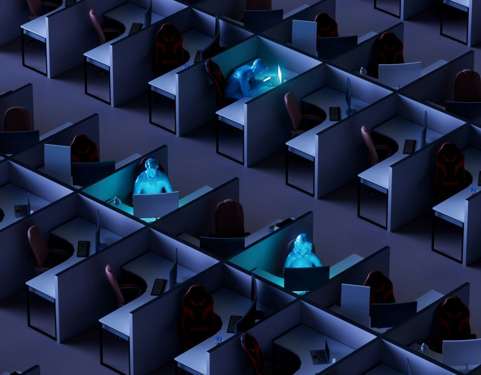 Illustration of office three workers hunched over their desks after hours, surrounded by many empty desks 