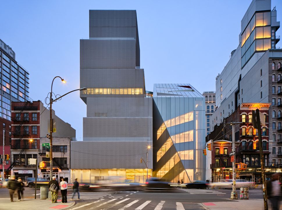 Exterior view of the New Museum at dusk, with its distinctive stacked aluminium mesh volumes rising above the intersection of Bowery and Prince Street in Manhattan, New York.