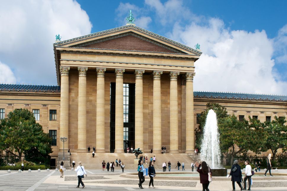 An exterior street view of a majestic parthenon-like art museum