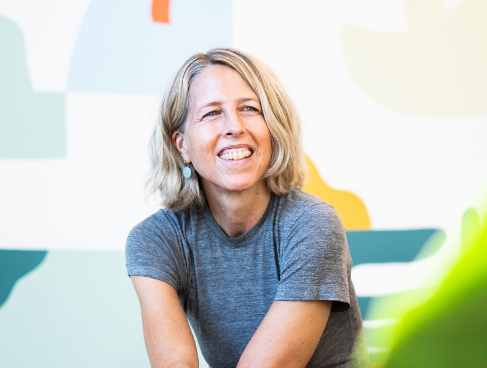 Woman in t-shirt sits in chair