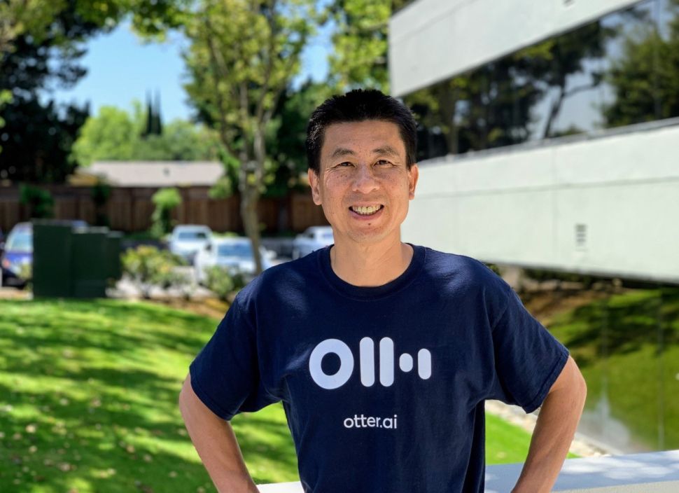 An Asian man in a navy blue shirt
